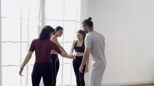 Happy group of diverse friends doing yoga in studio, meditating