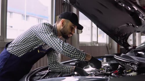 Car Service Repair Maintenance and People Concept Auto Mechanic Man with Lamp Working at Workshop