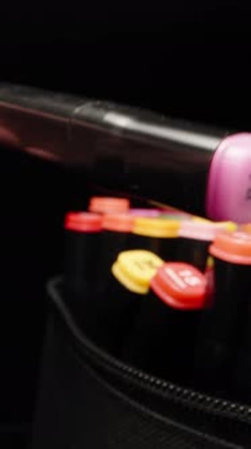 I take out a pink marker from a bag of colored markers. Dolly slider extreme close-up. Laowa Probe V