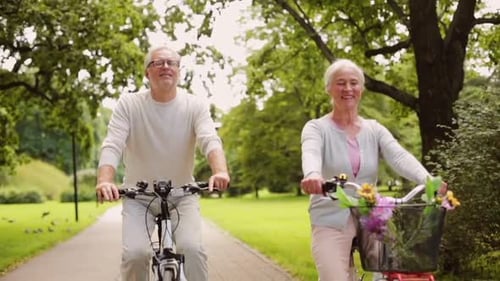 Active Old Age, People and Lifestyle Concept - Happy Senior Couple Riding