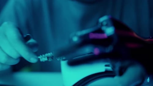 Robotic Arm Working on Circuit Board in Blue Light