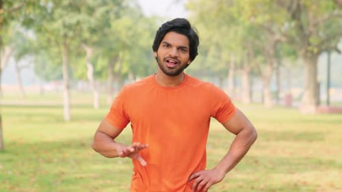 Man Explaining Outdoors in Urban Park Setting