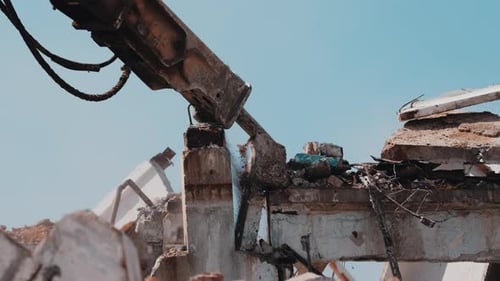 Excavator Hydraulic Hammer Breaking Concrete Column During Demolition Close Up