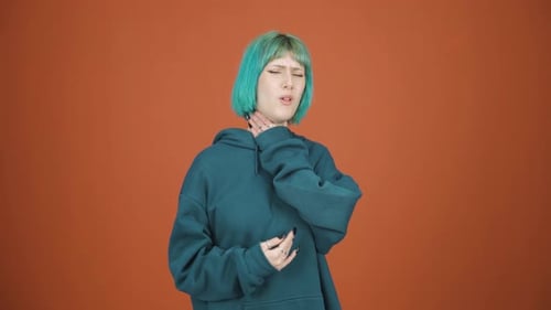 Young Woman Holding Sore Throat in Discomfort