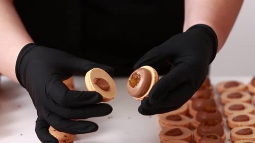 Assembling Macaroons with Black Gloves in Close Up