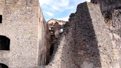 Professional 4K flight of the interior of an abandoned ruins of an ancient medieval castle high up i