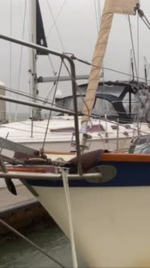 Closeup, bow of sailboat swaying in rough waters from hurricane storm surge