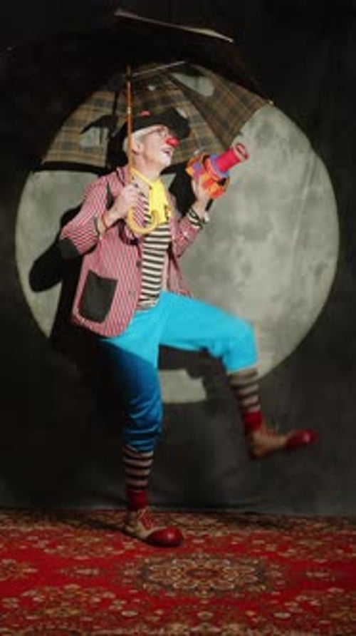 Clown with Umbrella and Toy Standing on Carpet