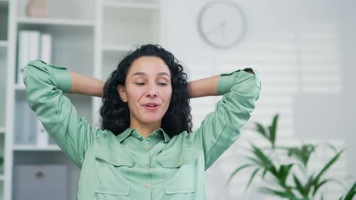 Satisfied glad young female worker employee relaxes after finishing work on a laptop computer Happy