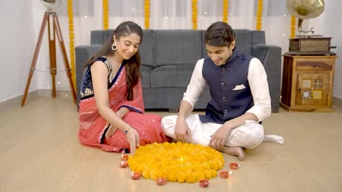 Young Couple Lights Candles and Decorates Flowers