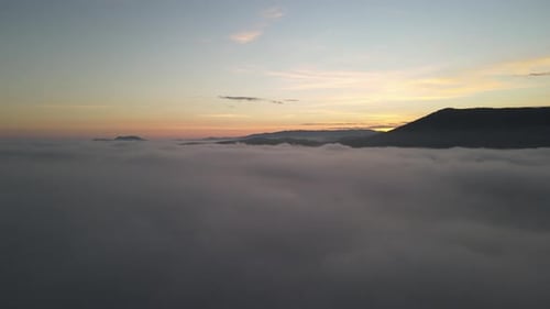 Majestic Fog Over Mountains at Sunrise