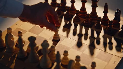 Fingers Pushing Initial Figure on Patterned Board with Shadows Player Starting