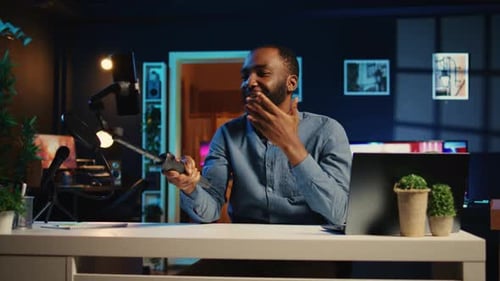 Young Adult Tech Vlogger in Home Studio