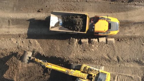 Aerial View of Excavator Loading Dump Truck