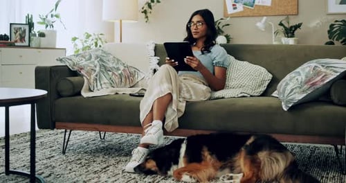 Woman Using Tablet with Dog at Home