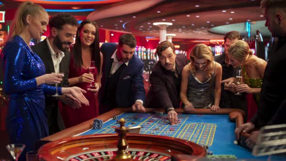 Multiethnic Young Adults Playing an Engaging Game of Roulette, Spending ...