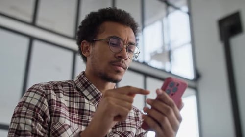 Man Browsing Online Using Smartphone