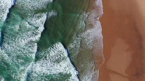 Tropical beach aerial view, Top view of waves break on tropical yellow sand beach. Sea waves seamles