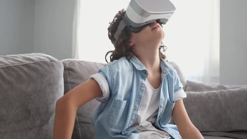 Child Immersed in Virtual Reality on Couch