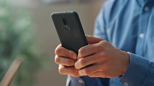 Man's Hands Using a Smartphone
