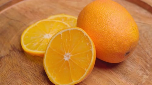 Fresh Orange Slices on Wooden Surface Rotating