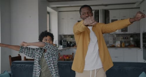 Slow Motion Portrait of Happy Father and Child Dancing Having Fun Together in Apartment