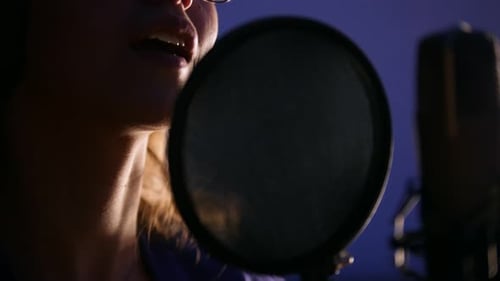 A Young Woman Recording a Song in the Studio