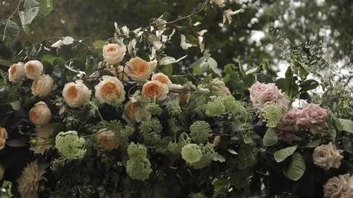 Close up to a beautiful floral arch with beautiful colors placed at a wedding celebration