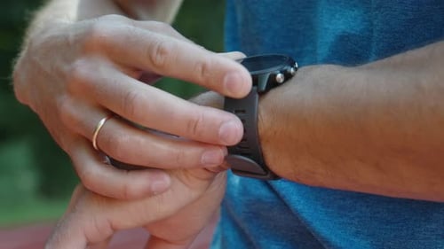 Man Interacts With Fitness Tracker On Wrist
