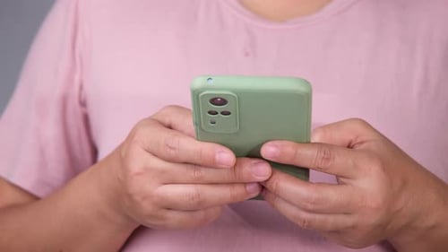 Asian female hand using mobile phone to text or chat. Close up of woman using smart phone