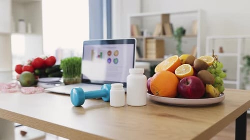 Healthy food and dumbbell on the table