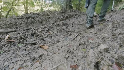 Hiker Walk On Muddy Trail Uphill