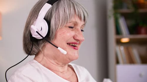 Senior Woman Smiling Wearing Headphones in Home