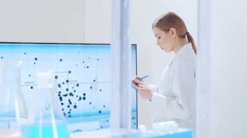 Woman Scientist Writing Data in Modern Laboratory