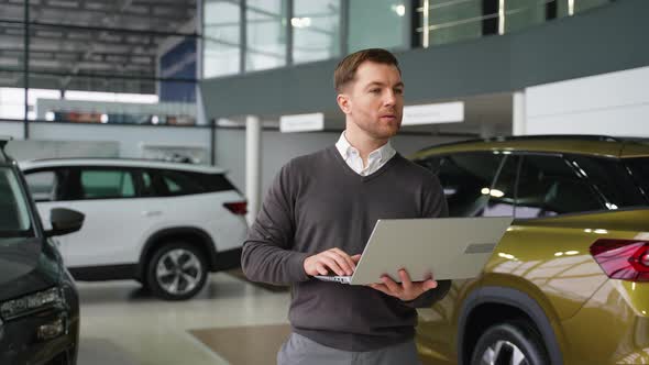 Man Typing on Laptop in Car Showroom, People Stock Footage ft ...