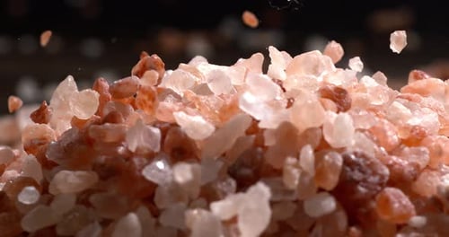 Himalayan pink salt in a super slow motion, natural mineral seasoning for healthy cooking and spa