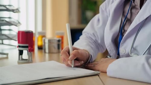 Doctor Signing and Stamping a Medical Document