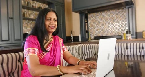 Woman Working on Laptop at Home
