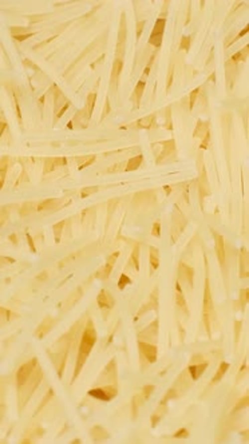 Macro Video of Instant Noodles Spinning in a Circle Raw Macaroni Top View Vertical Video