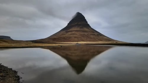 Aerial view of kirkjufell mountain reflection in calm water, Iceland.