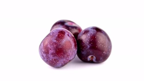 Close Up of Three Rotating Plums