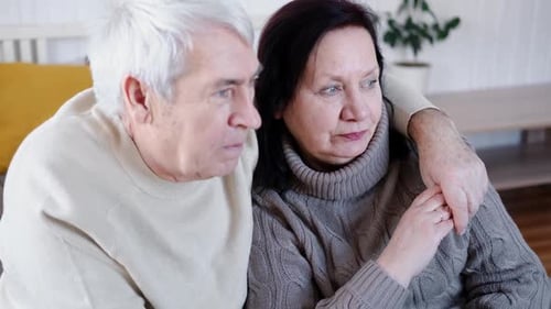 Loving Senior Couple Embrace Affectionately in Home Setting