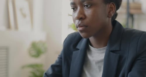 Closeup of Female Entrepreneur Working with Laptop Typing Sitting at Desk in Office