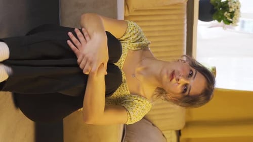 Young Woman Sitting on Floor Hugging Knees