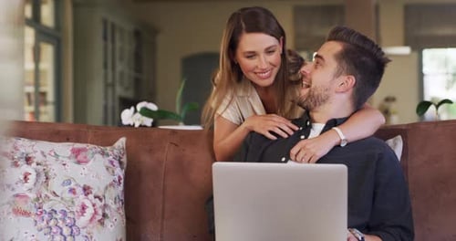 Young Couple Using Laptop in Living Room