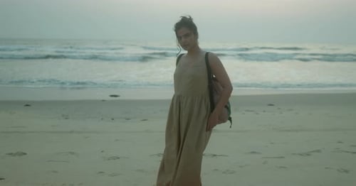 Woman Posing on a Beach at Sunset