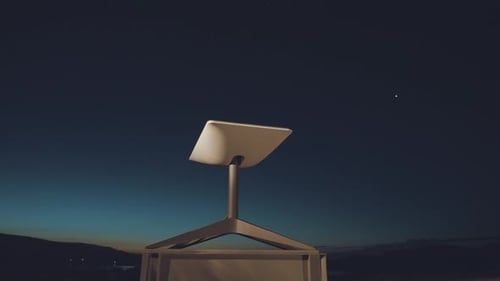Close-up shot of moving satellite internet receiver dish at night. Future.