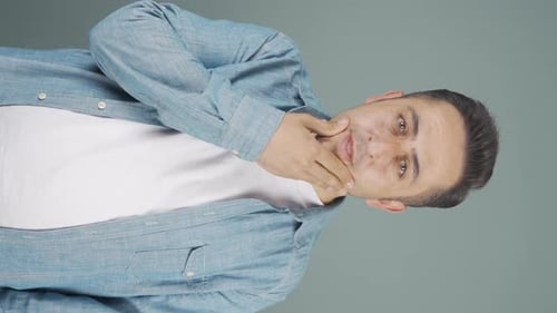 Vertical video of Thoughtful man towards camera comes up with an idea.