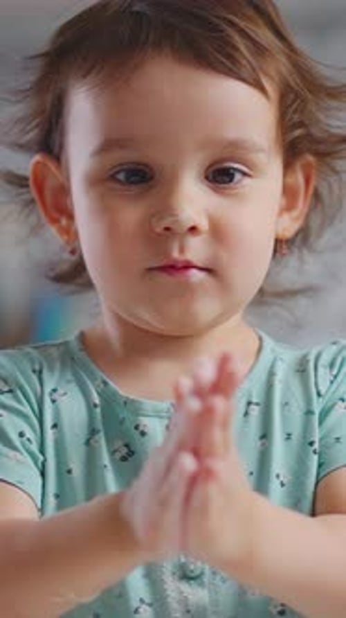 Adorable Girl Clapping Hands in Studio Close Up