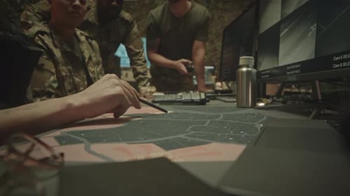 Soldiers Planning Mission in Dark Command Center